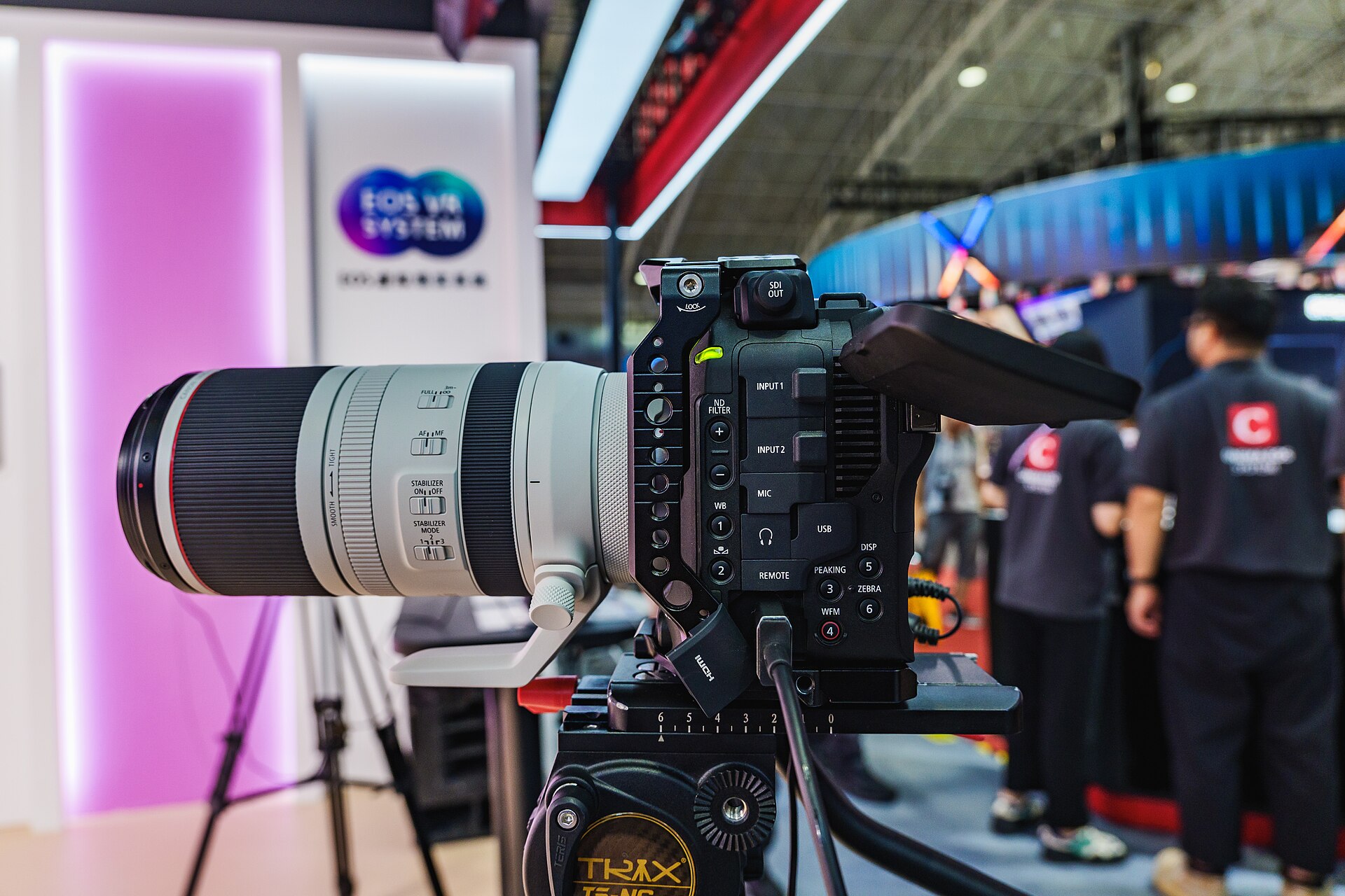 Canon EOS C80 fitted with an RF 70–200mm lens at a trade show