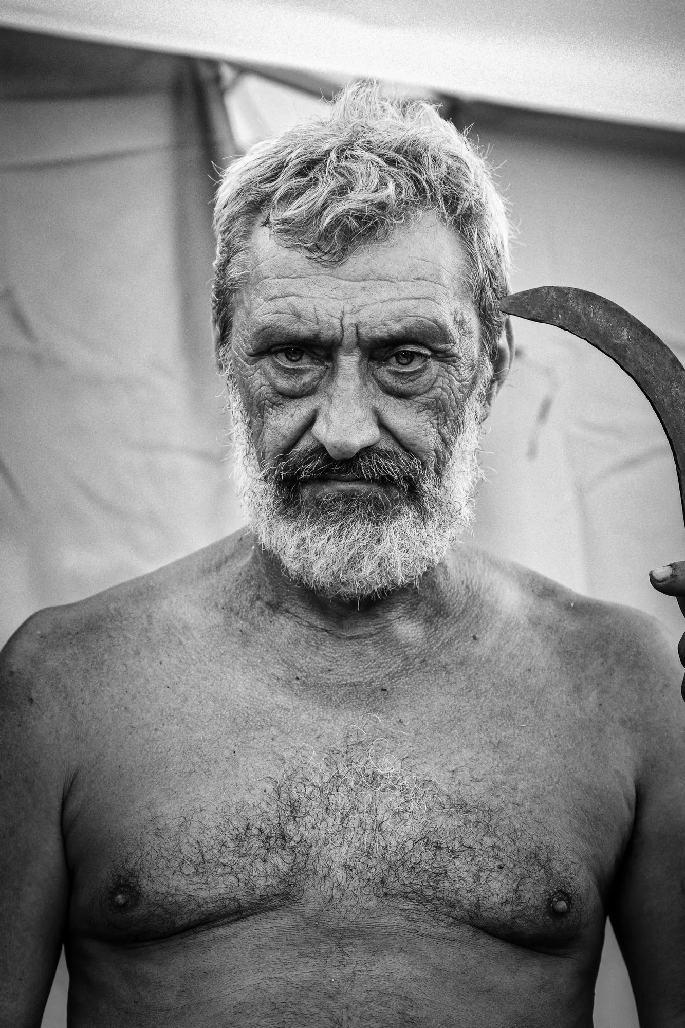 Direct black-and-white portrait of a rugged man