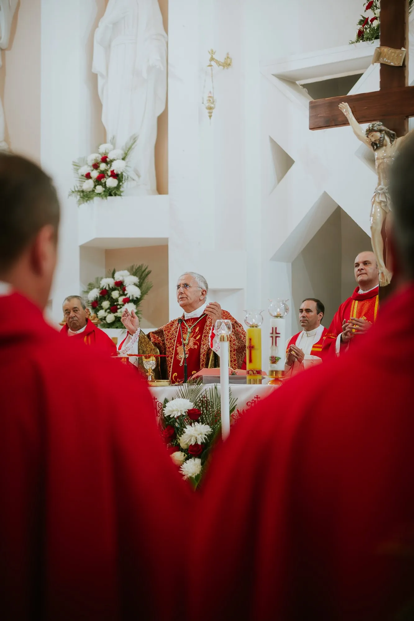 Church altar framed between two red vestments