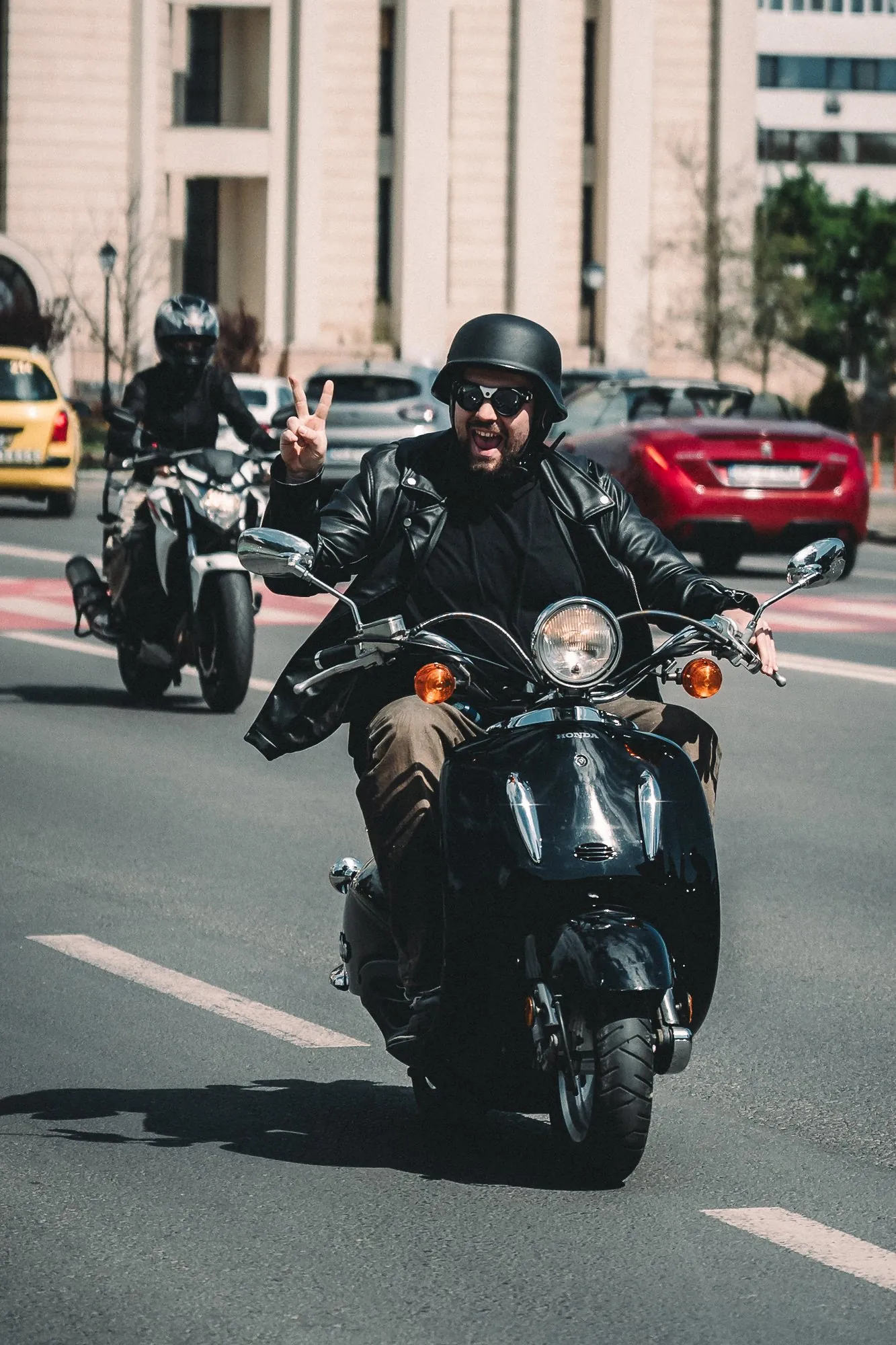 Motorcyclists riding together through a city street