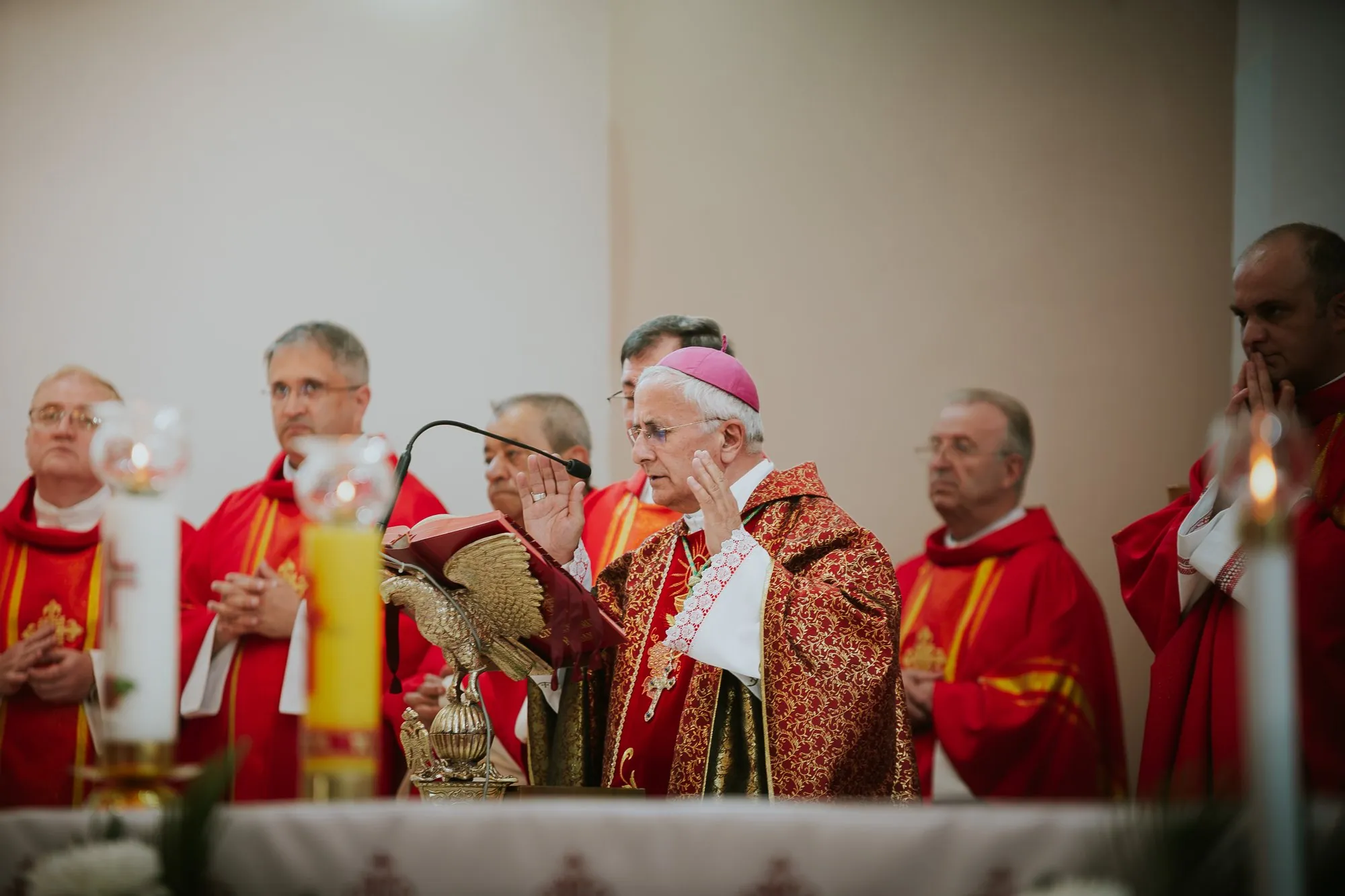 Clergy in red vestments during a church ceremony
