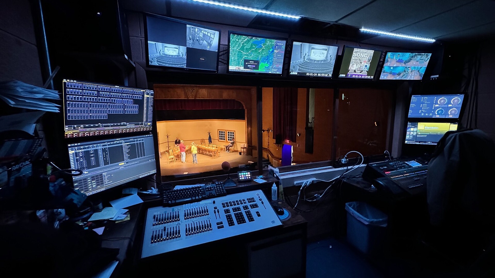 Modern theatre control booth with lighting and sound equipment