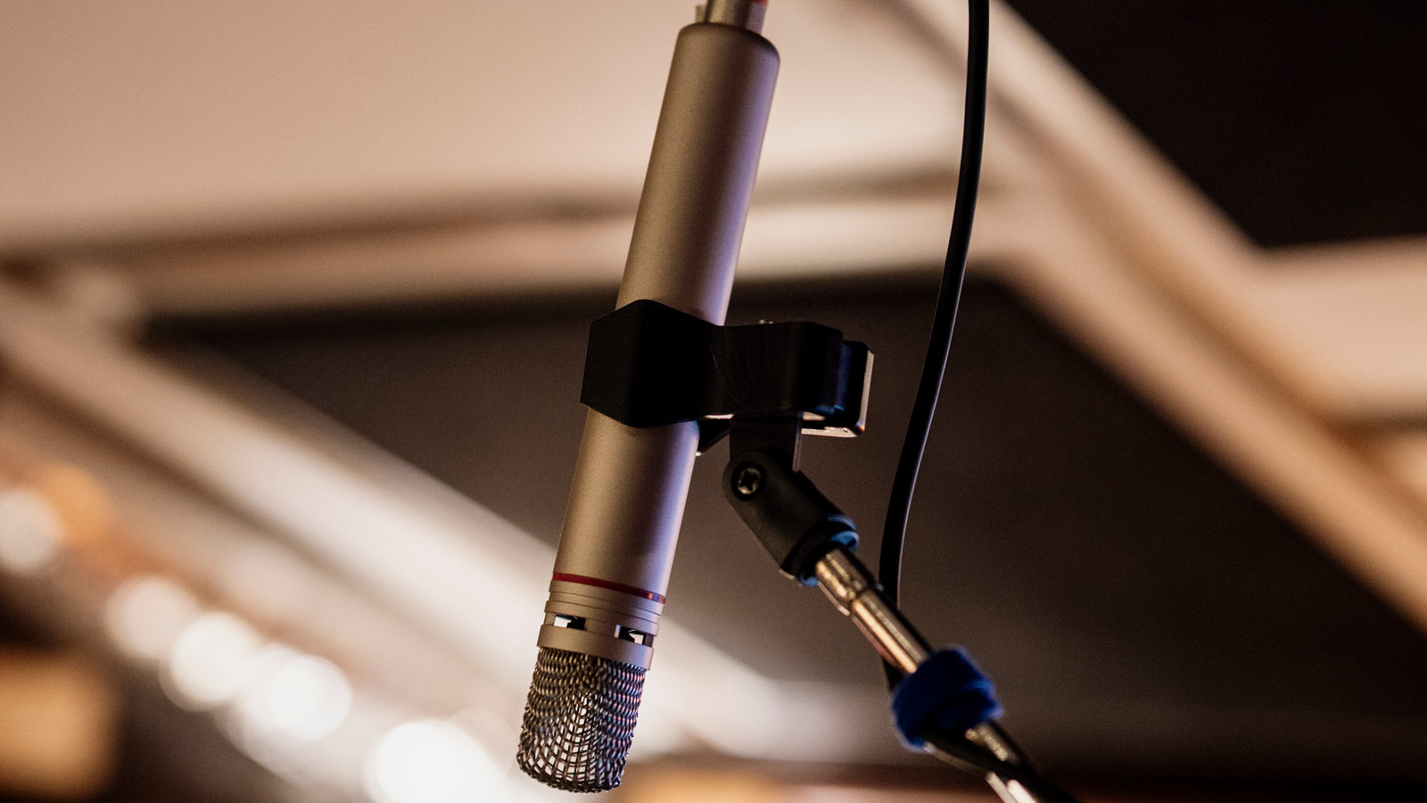 A close view of a real microphone in a recording studio; this is context, not Google Vids, Gemini Omni or a generated avatar.