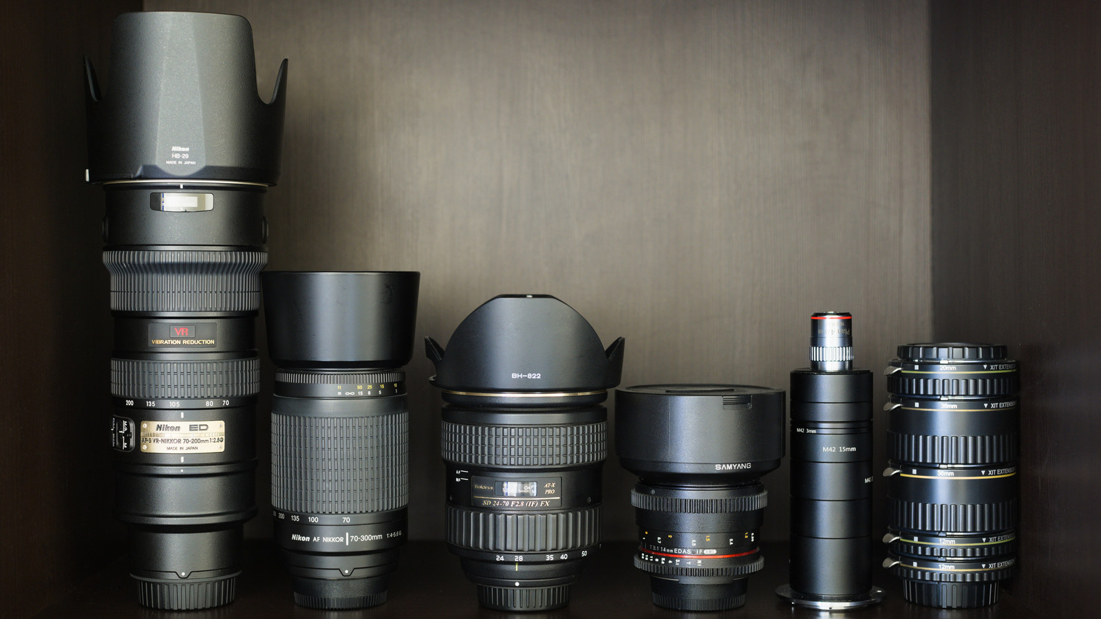 A real collection of different photographic lenses and extension tubes; this is context, not one manufacturer’s current lineup.