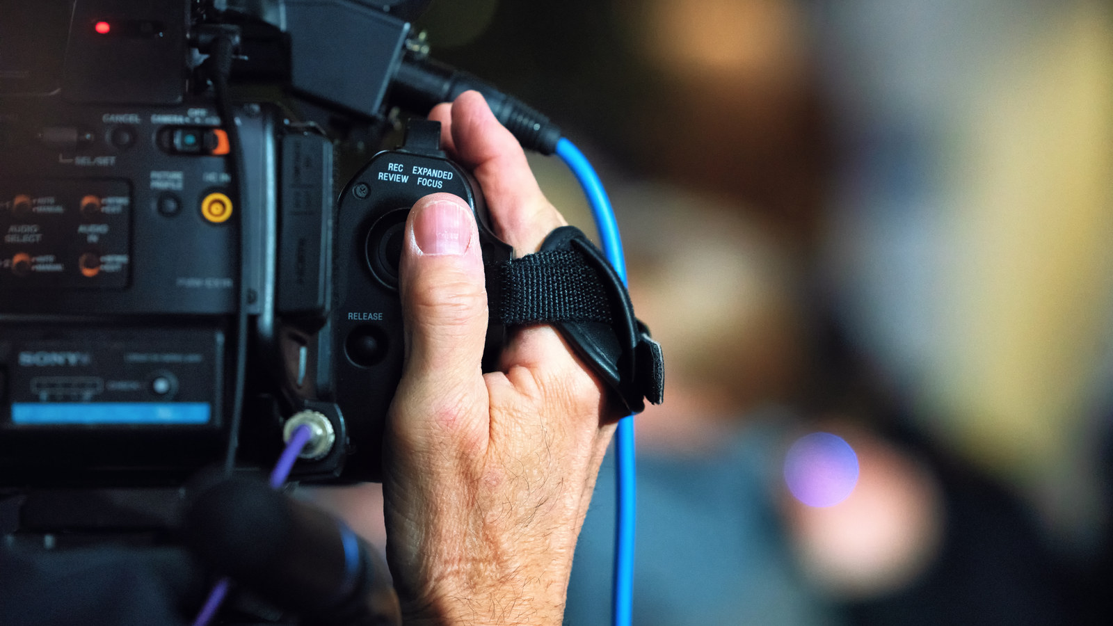 A camera operator at a 2019 press conference; this is newsroom context, not NVIDIA or a July 2026 event.