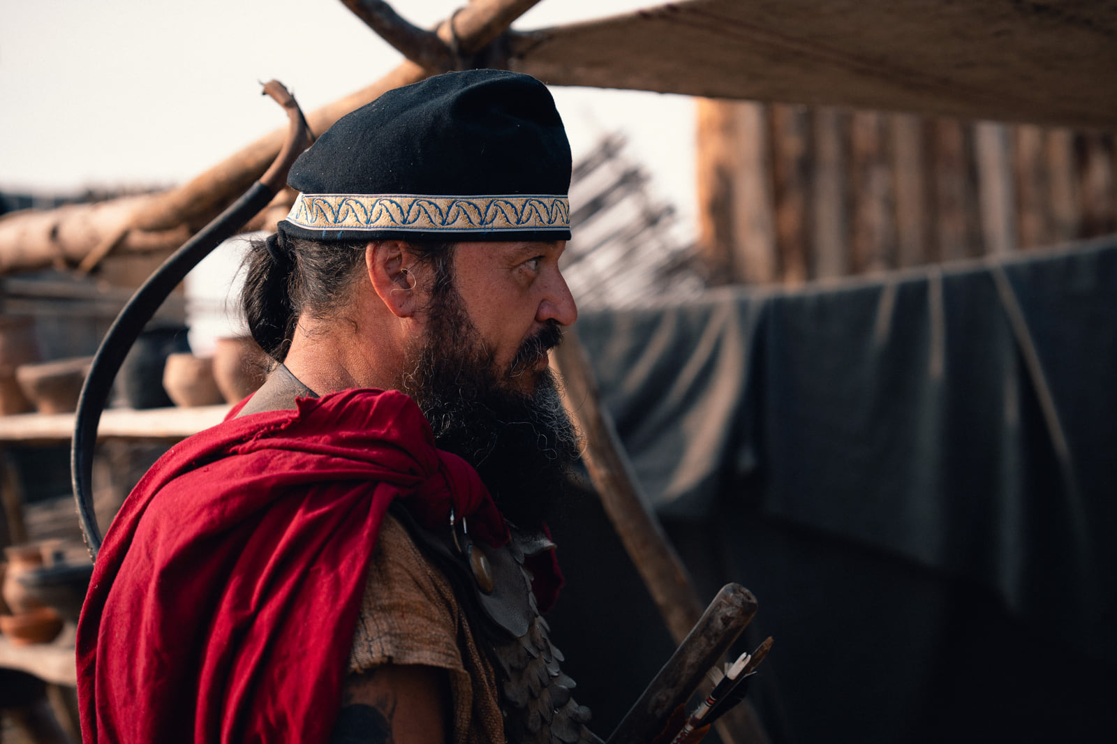 Profile portrait of a historical archer in warm outdoor light before MANAZYR scene layers